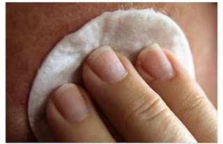 Using neat towel to clean face